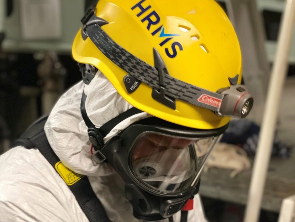 HRMS Worker with Safety Gear in High-Risk Environment